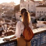 solo-international-traveler-in-greece-overlooking-balcony