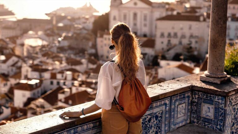 solo-international-traveler-in-greece-overlooking-balcony