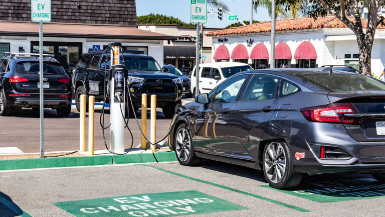 electric-vehicle-being-charged-at-ev-charging-station-inside-restaurant-business-parking-lot