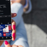 woman-holding-mobile-phone-showing-universal-business-solutions-instragram-profile