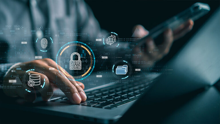 close-up-of-male-hand-pressing-keys-on-laptop-keyboard-while-digital-icons-of-cybersecurity-hover-over-them