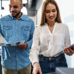 Office workers using Epson multifunction printer for color print materials in modern business environment