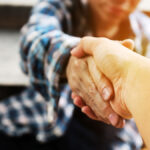 homeless-woman-reaching-her-hand-out-to-grab-another-hand-for-help
