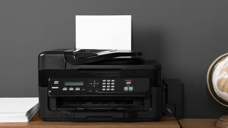 black-wireless-printer-on-console-table-next-to-printer-paper-and-wooden-globe